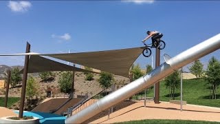Crazy biker jumps off huge slide tower!