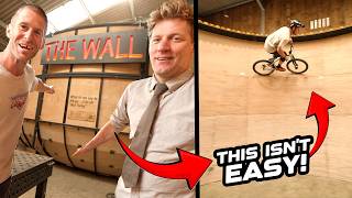 RIDING A MOUNTAIN BIKE ON COLIN FURZE WALL OF...