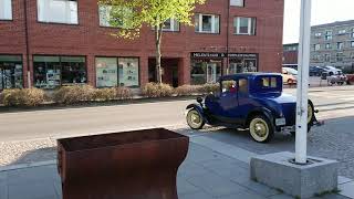 14 may 2019: A blue classic car driving away.